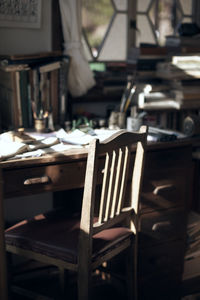 Empty chair and table with documents in office