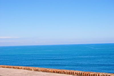 Scenic view of sea against clear blue sky