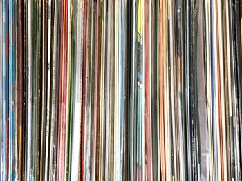 Full frame shot of compact disc arranged on shelf
