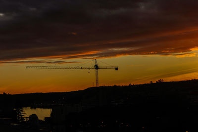 Silhouette electricity pylon against sky during sunset