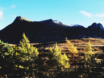 Scenic view of mountains against blue sky