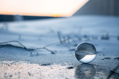 Close-up of crystal ball on beach