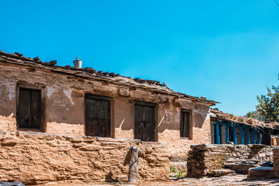 Low angle view of old building against blue sky