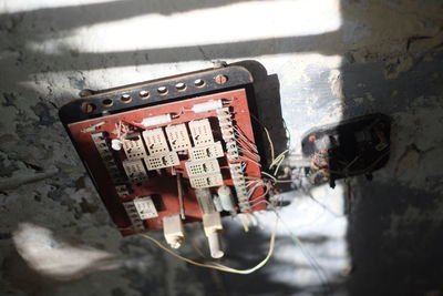 High angle view of electrical switchboard on weathered wall