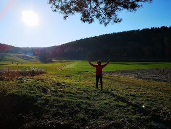 Full length of person standing on field against sky