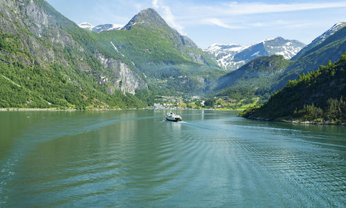 The photo shows a passenger ferry entering the geirangerfjord in norway
