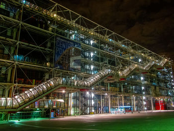 Low angle view of illuminated buildings in city at night