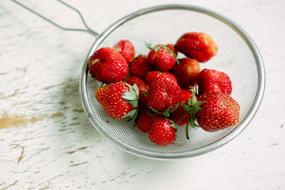 Bright sweet and juicy strawberries . red strawberries in an iron colander. drops of water on a berr