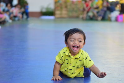 Portrait of happy boy playing in swimming pool