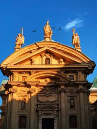 Low angle view of historical building against blue sky