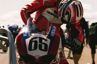 Racer sitting on motorcycle