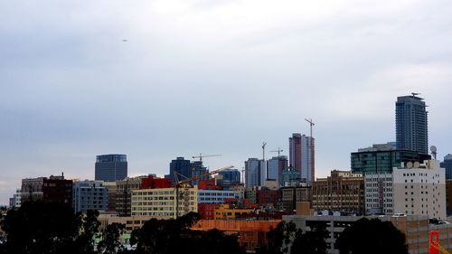 Buildings in city against sky