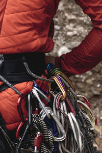 Close-up of a climber's harness with a lot of climbing equipment