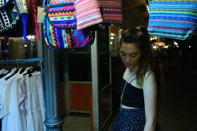 Portrait of young woman standing in store