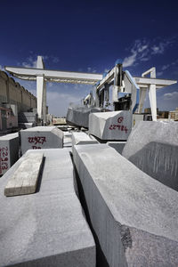 Construction site by bridge against sky