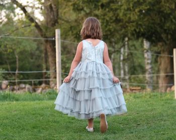 Rear view of a girl looking away on field