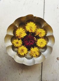 Directly above shot of yellow flowers on wood
