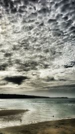 Scenic view of calm sea against cloudy sky