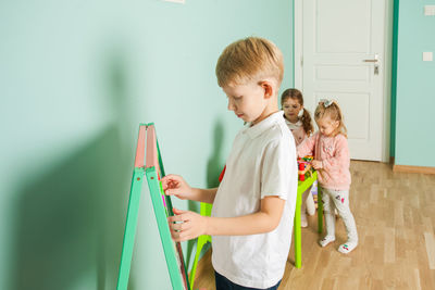 Siblings standing on floor