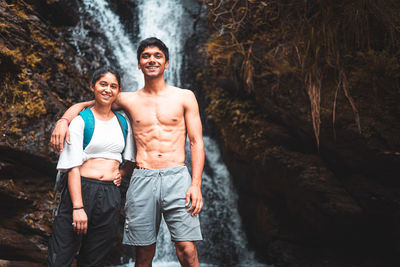 Young couple enjoying the beautiful waterfall view.