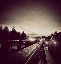 View of railway tracks against sky at sunset