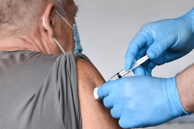 Doctor vaccinating senior man. elderly people vaccination. covid 19 coronavirus vaccine injection