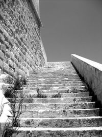 Low angle view of staircase by building against clear sky