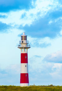 Low angle view of lighthouse against cloudy sky