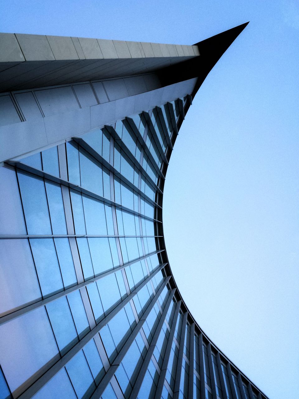 architecture, built structure, low angle view, building exterior, modern, clear sky, city, tall - high, skyscraper, office building, tower, architectural feature, directly below, building, blue, pattern, day, glass - material, no people, sky