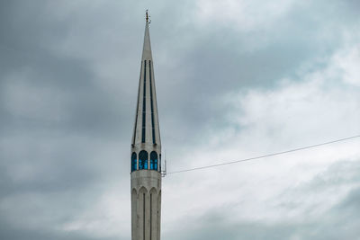Low angle view of cross on building against sky