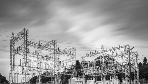 Low angle view of electricity pylon against sky