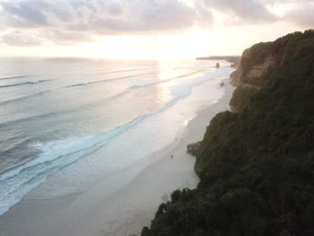 Scenic view of beach against sky during sunset