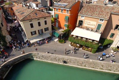 High angle view of people on street amidst buildings in city