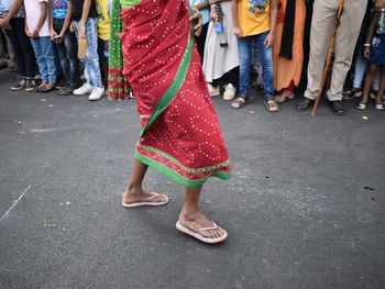 Low section of women standing on road
