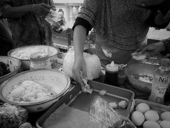 Midsection of woman having food at kitchen