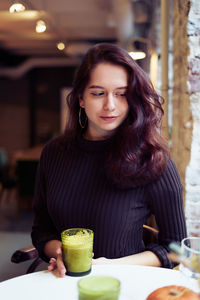 Woman having drink at cafe