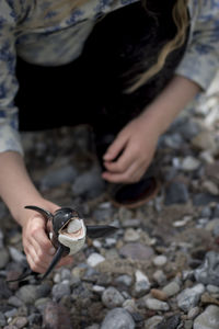 Low section of woman holding toy