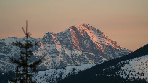 Scenic view of snowcapped mountains against sky during sunset