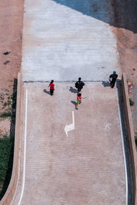 High angle view of people walking on road