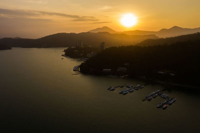 Scenic view of silhouette mountains against sky during sunset