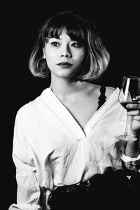 Portrait of a beautiful young woman over black background