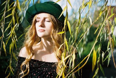 Portrait of beautiful young woman with plants