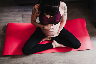 High angle view of woman sitting on floor