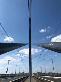 Road by bridge against sky