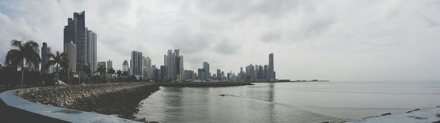 Buildings against cloudy sky