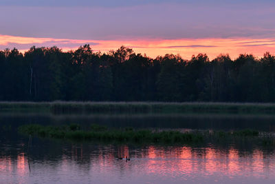 Scenic view of lake against sky at sunset