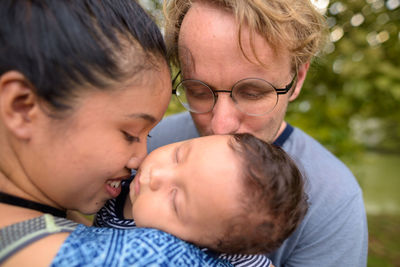 Portrait of mother with baby outdoors