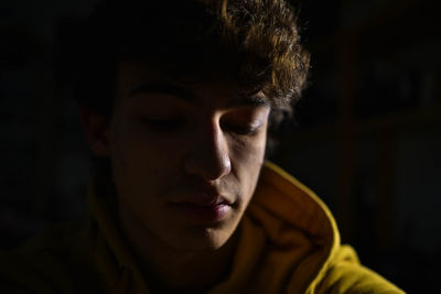 Close-up portrait of a young man looking away