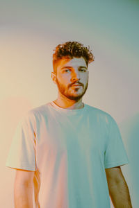 Portrait of young man standing against sky