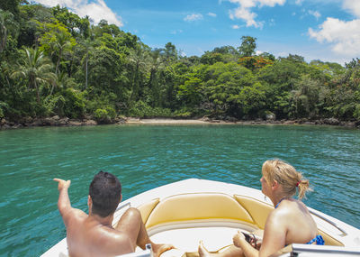 Couple approaching secluded beach on ilah grande / brazil